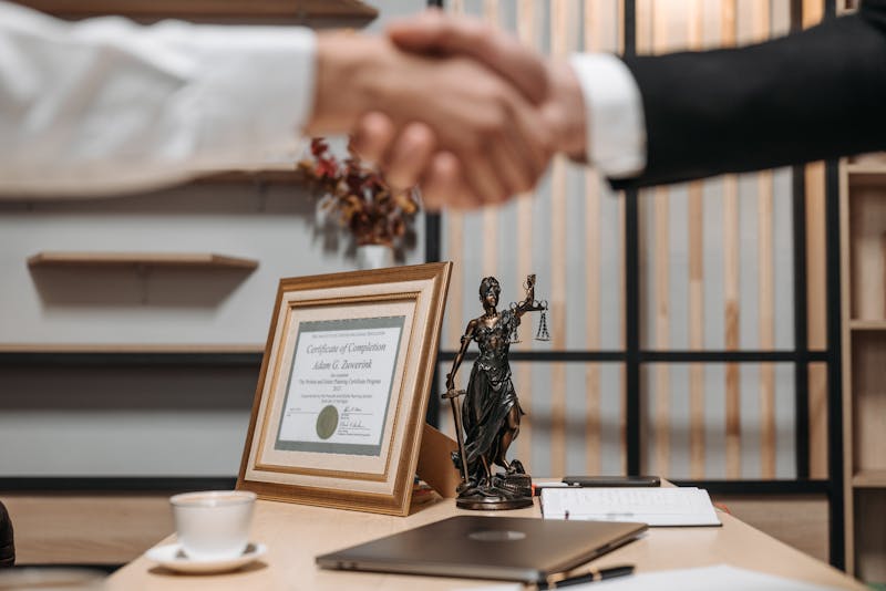a lawyer and a client shaking hands